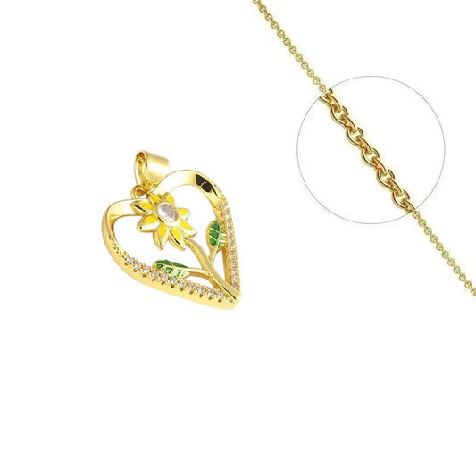 Collier doré chaîne et pendentif fleur dans un cœur orné de zirconiums sertis